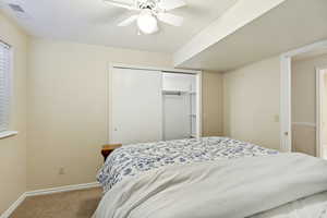 Neutral-toned bedroom featuring carpet flooring, a window with blinds, and white trim