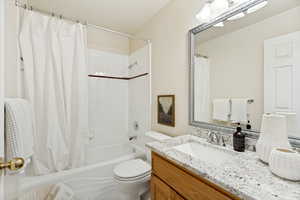 Bathroom featuring a built-in tub and shower combination with white tile surround and accent trim