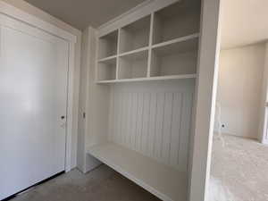 Built-in storage bench with beadboard detailing and open shelving