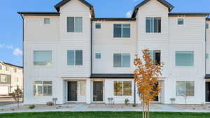 Modern townhouse exterior with white vertical and horizontal siding