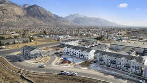 Community featuring newly constructed townhomes, mountain scenery, and a central playground area