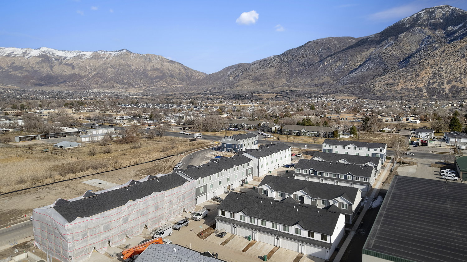 Townhome community with mountain scenery, multiple buildings, and varied rooflines