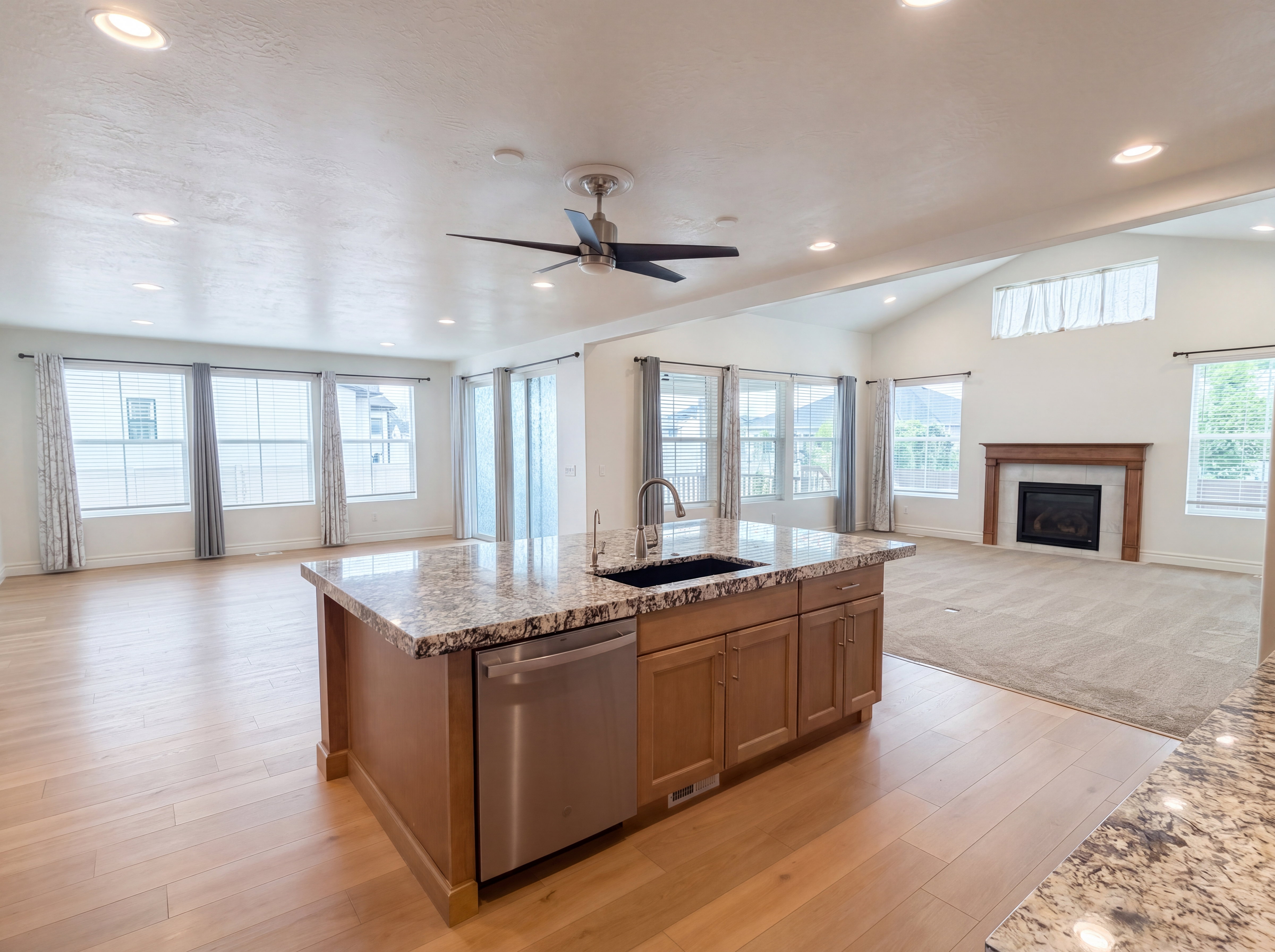 Kitchen island with a granite-style countertop and undermount sink