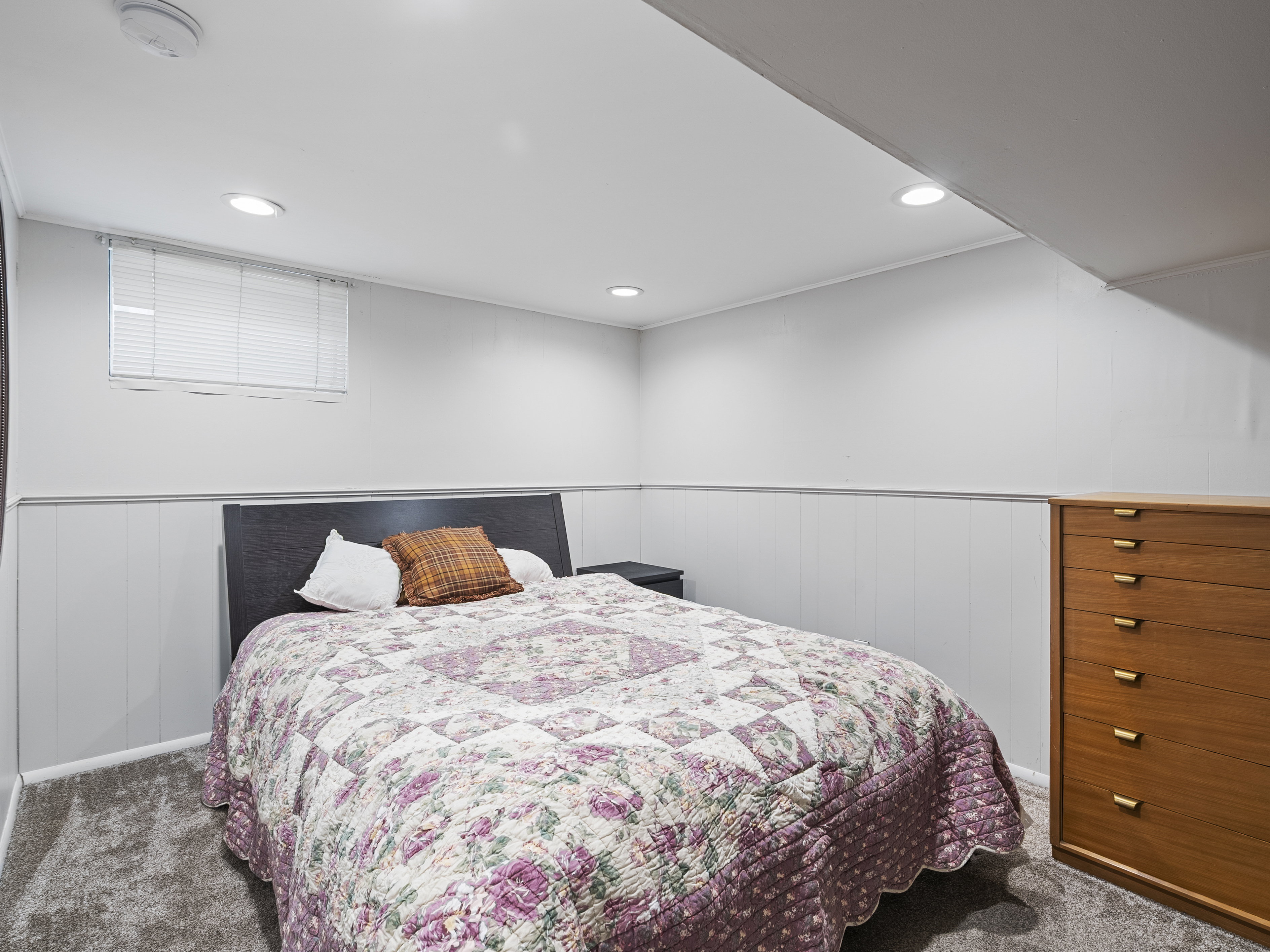 Bright interior space featuring recessed lighting and a window with blinds
