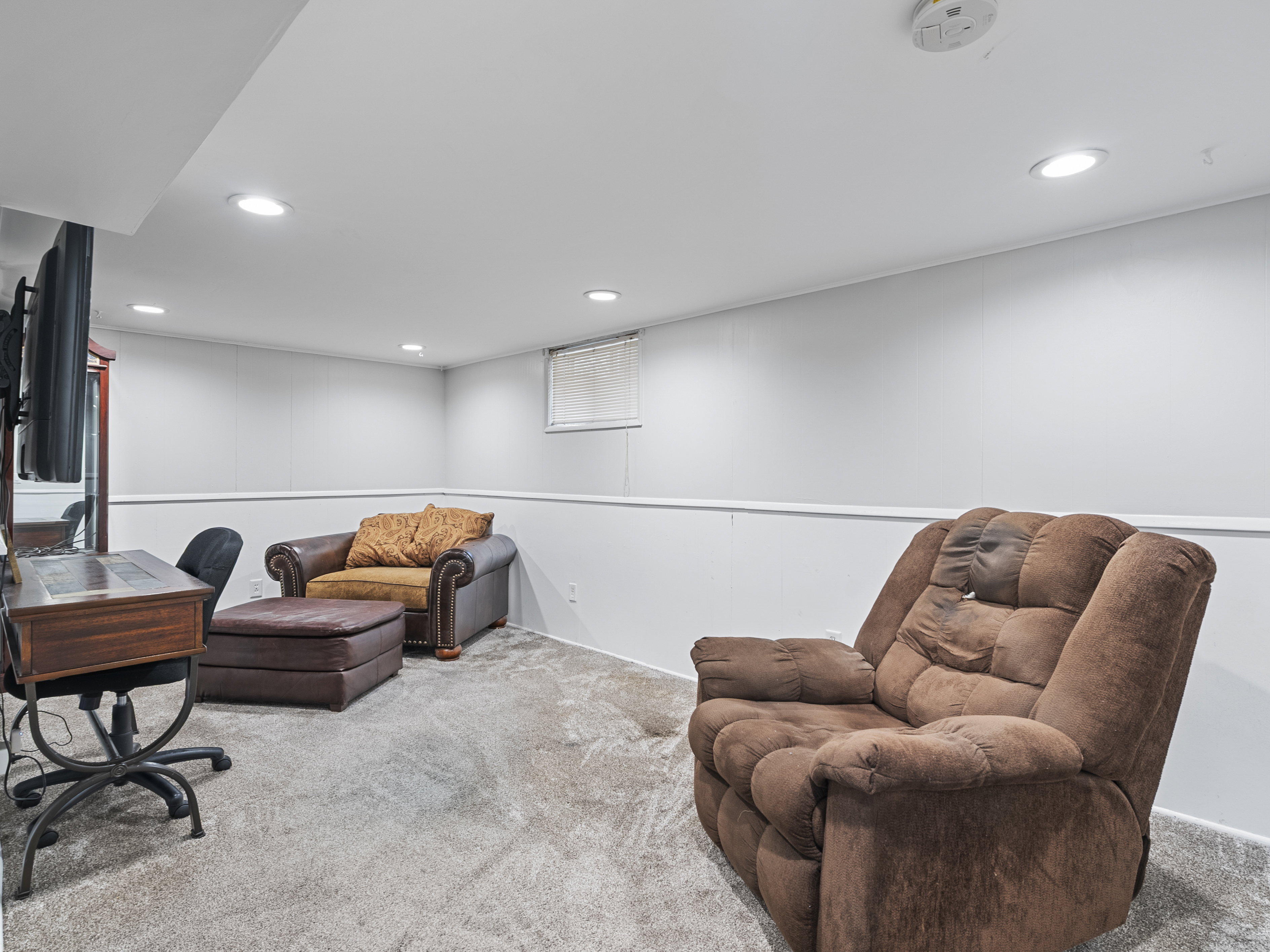 Finished lower level offering recessed lighting, light gray carpet, white walls, and white trim