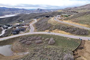 Hillside property featuring paved roads, established homes, and undeveloped lots
