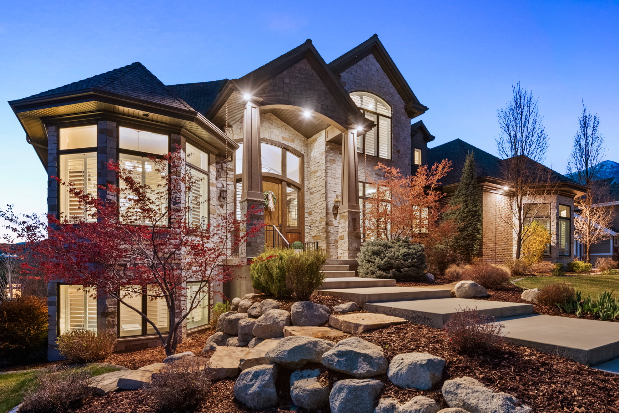 Stone-clad exterior featuring a prominent bay window
