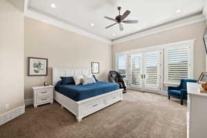 Spacious room featuring vaulted ceilings with recessed lighting, an overhead ceiling fan, and extensive crown molding