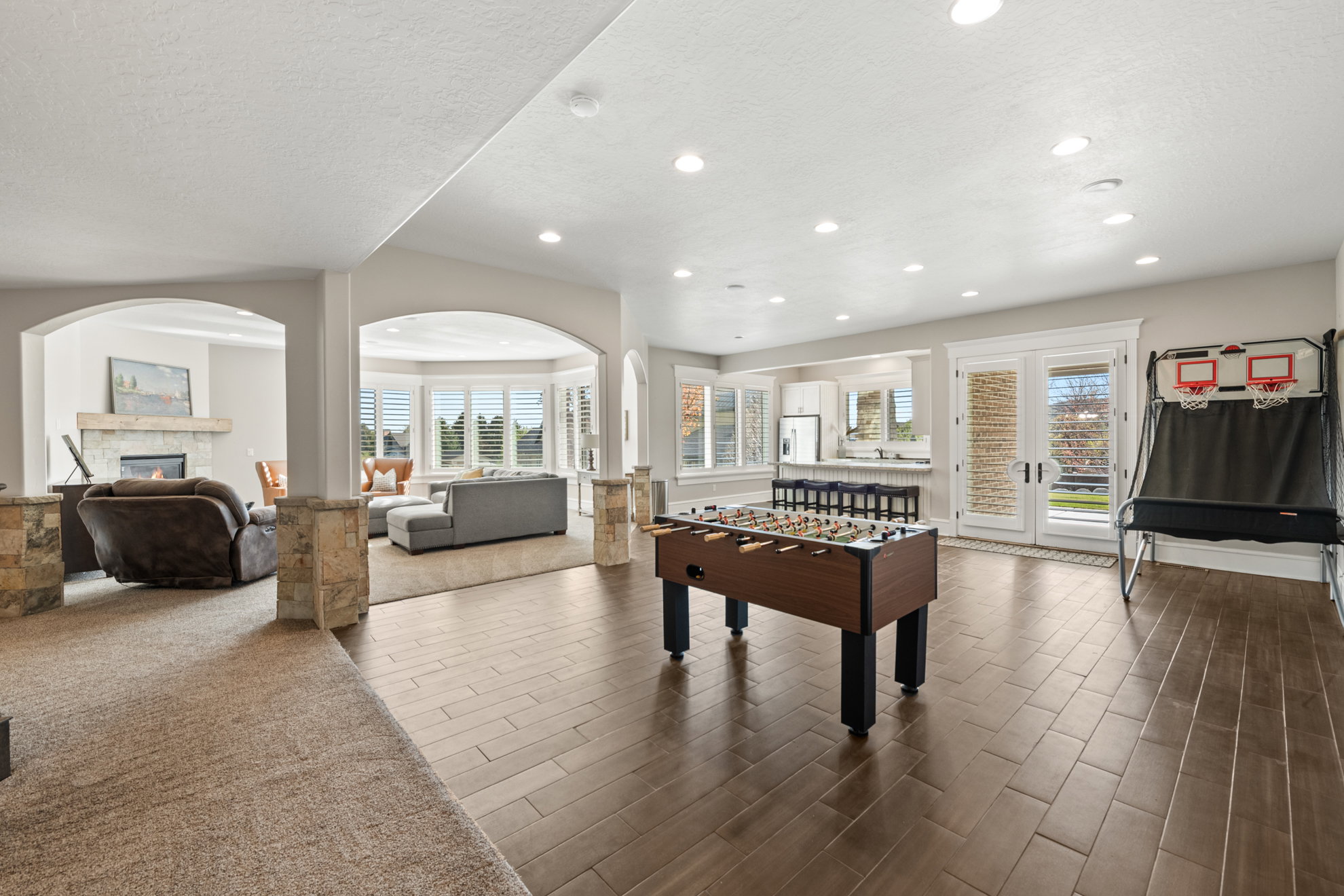 Spacious lower level featuring wood-finish flooring, recessed lighting, and white trim