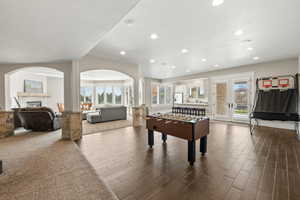 Spacious lower level featuring wood-finish flooring, recessed lighting, and white trim