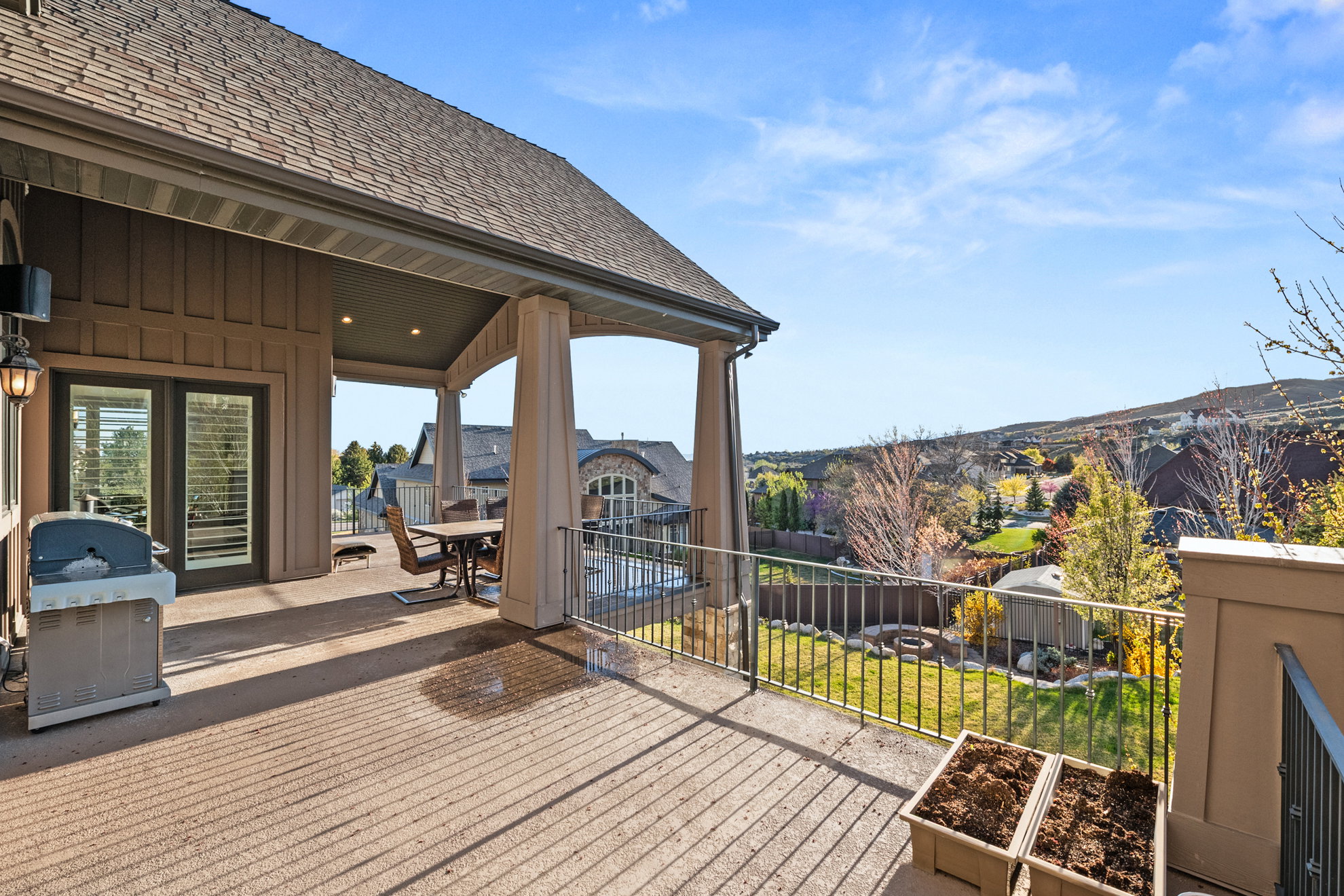 Expansive covered deck featuring recessed lighting, a ceiling fan, and access through double glass doors with interior shutters