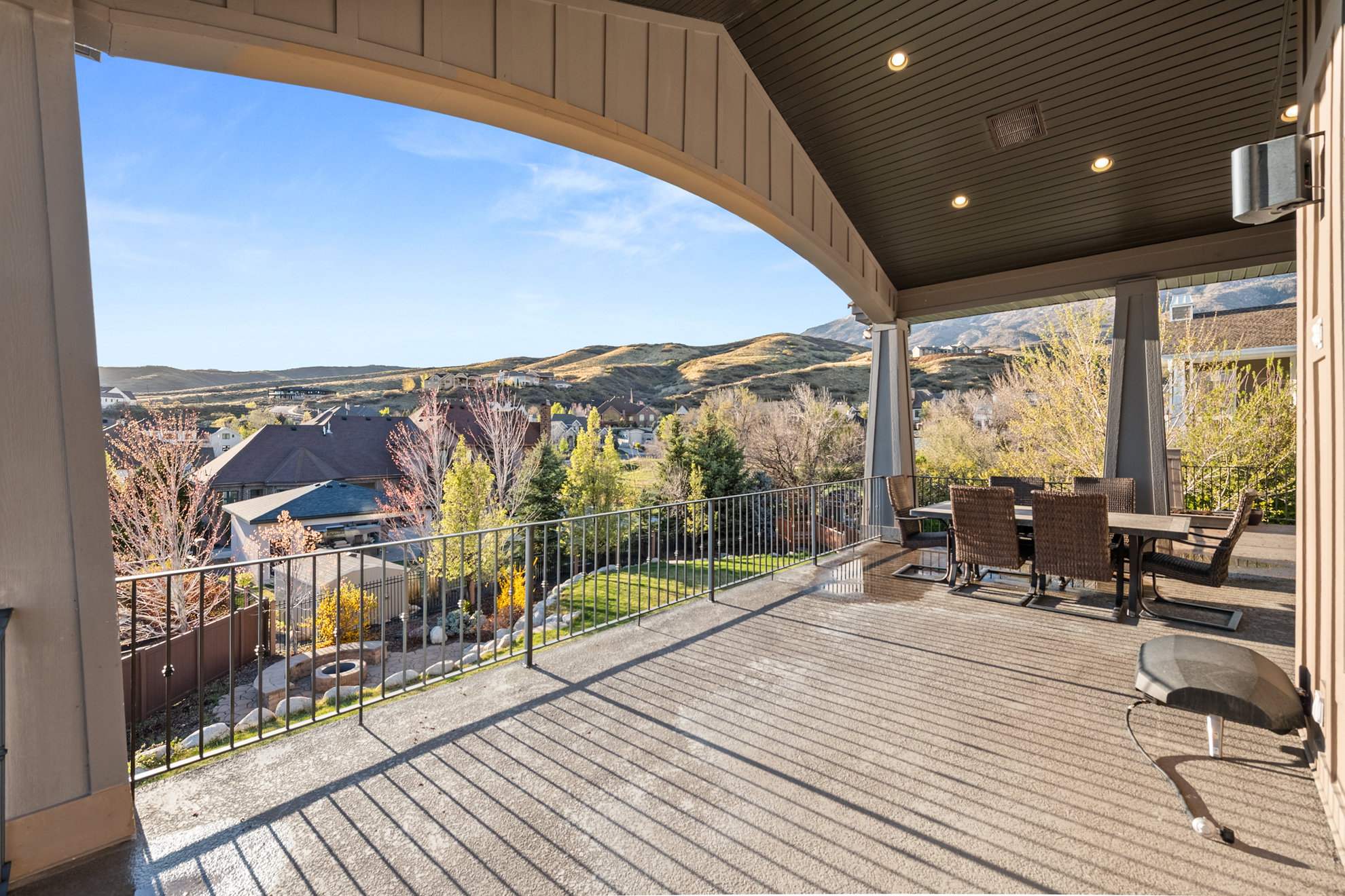 Expansive covered patio featuring a concrete surface, recessed lighting, and an arched beam structure