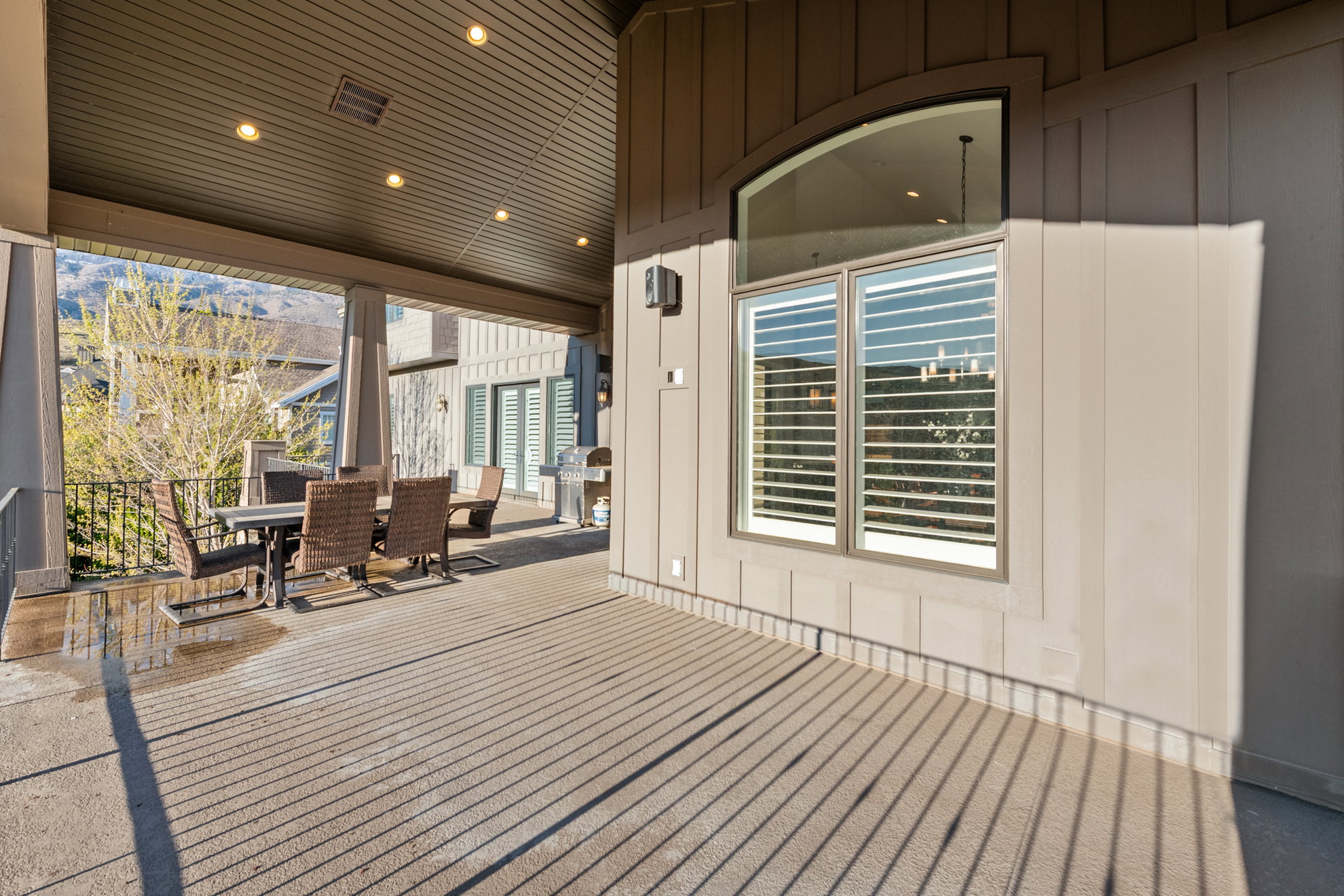 Covered patio featuring recessed lighting, a slatted ceiling, and an arched transom window