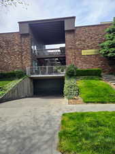 Brick facade building featuring multiple levels of balconies with white railings