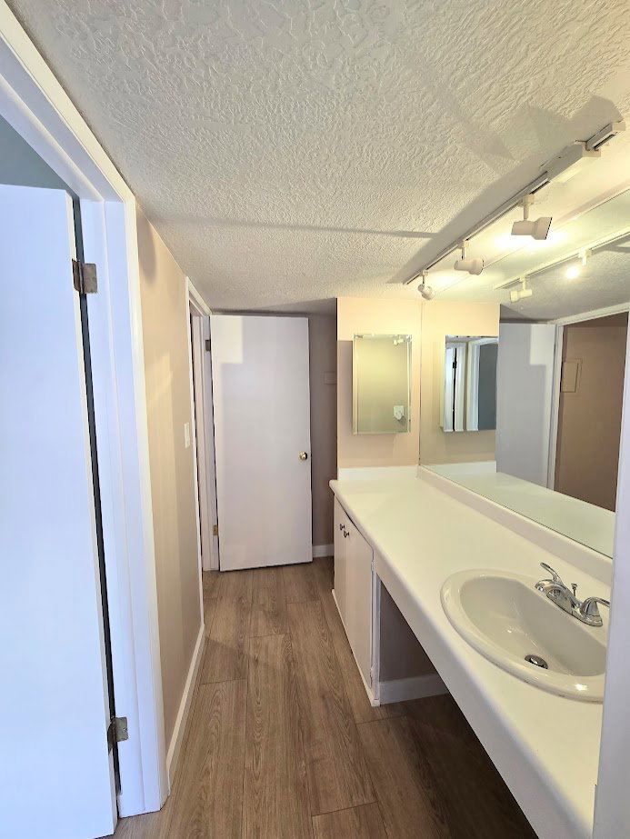 Spacious bathroom vanity with an integrated sink, polished chrome faucet, and ample counter space