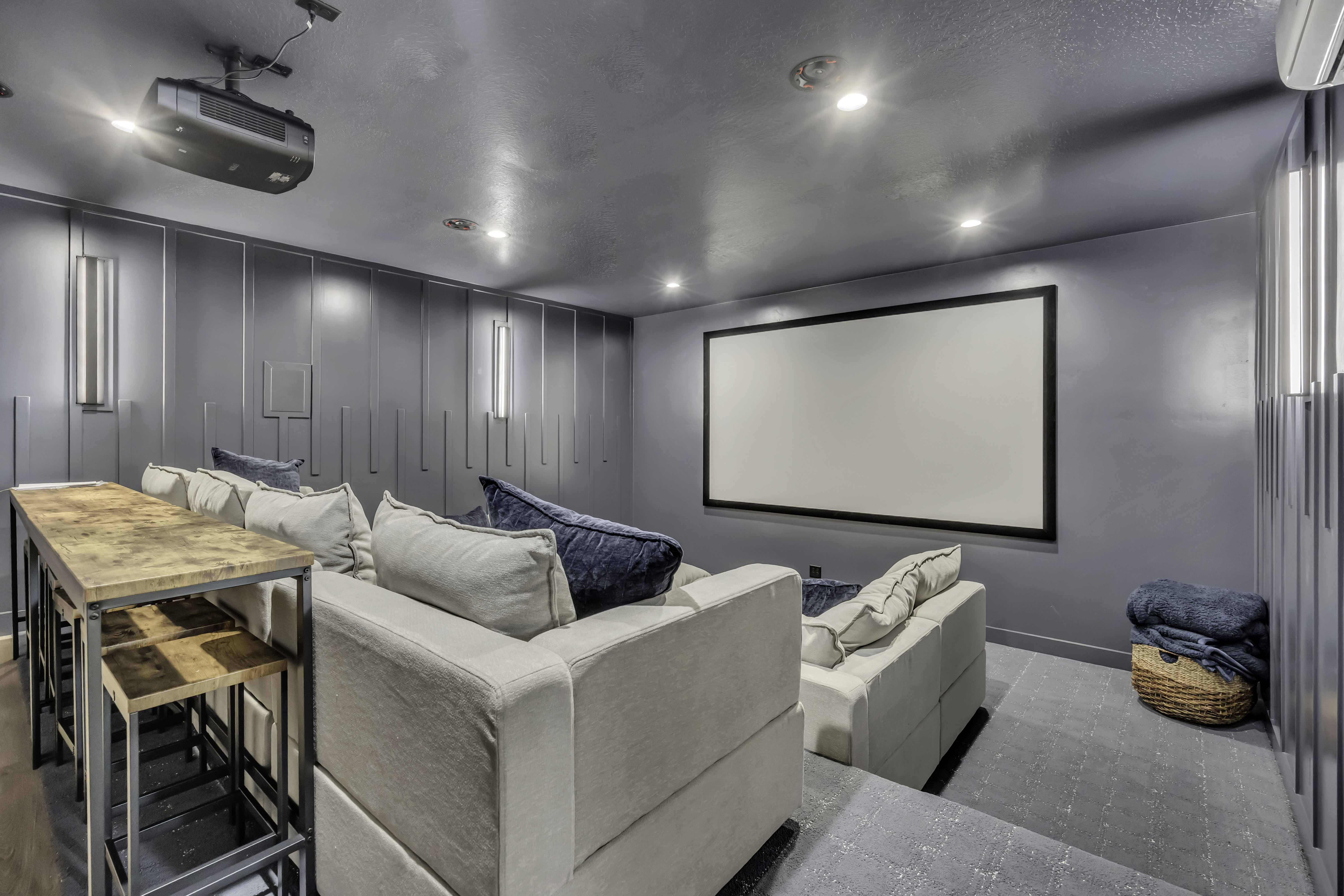 Home theater room featuring a decorative wall, recessed lighting, and a textured ceiling