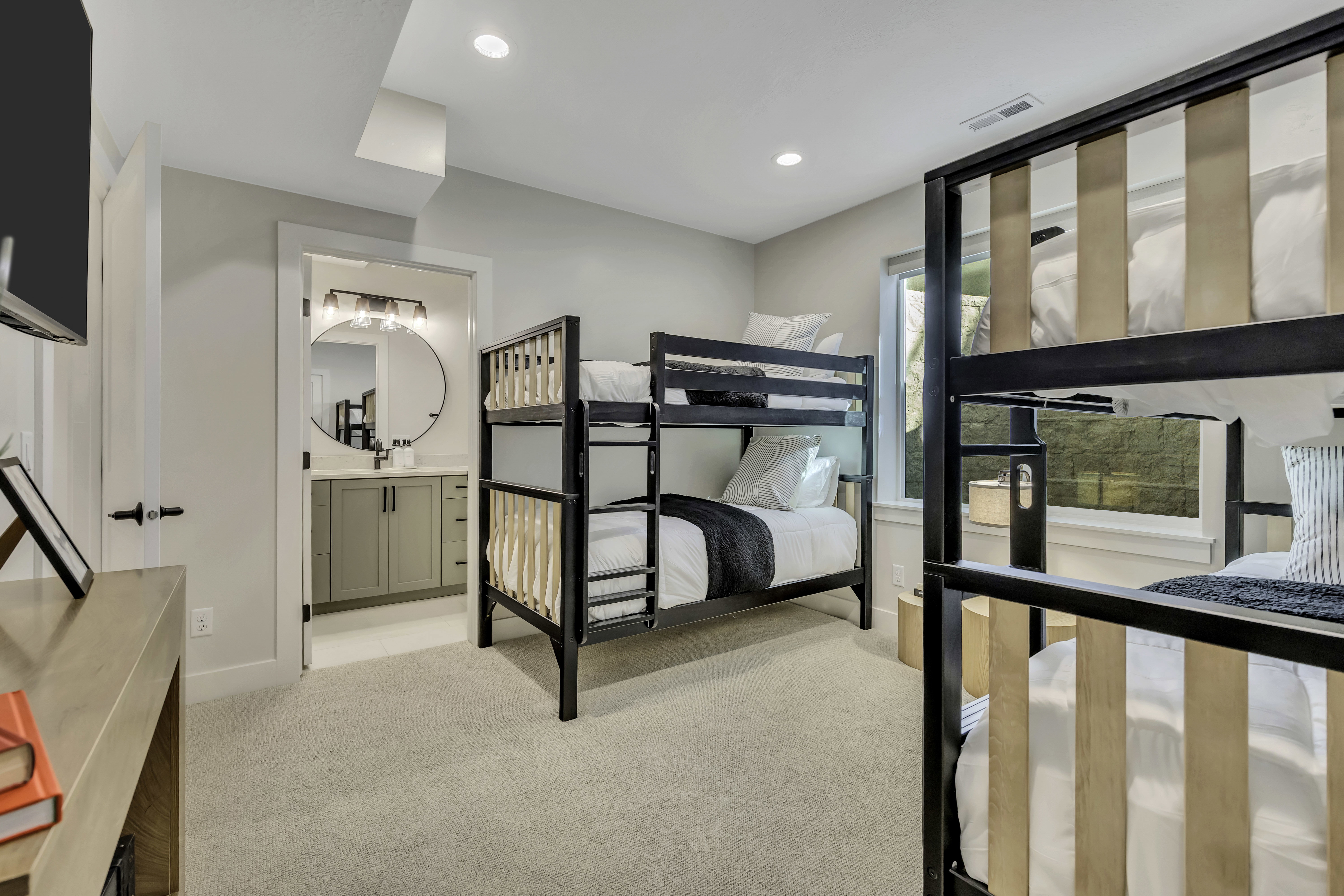 Unfurnished bedroom featuring light carpet, recessed lighting, and ensuite bath