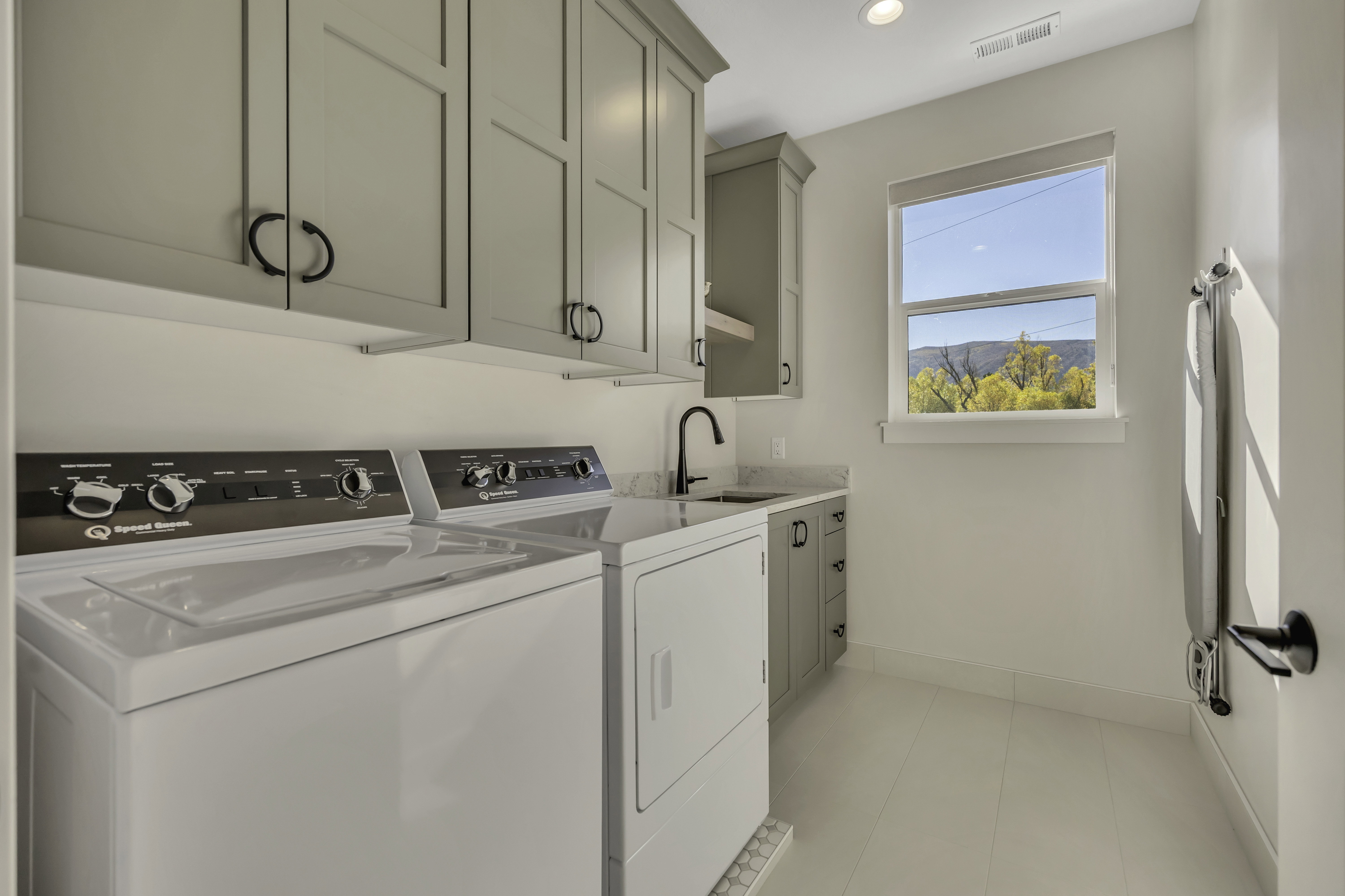 Laundry room featuring cabinet space, washer and clothes dryer, recessed lighting, and light tile patterned floors