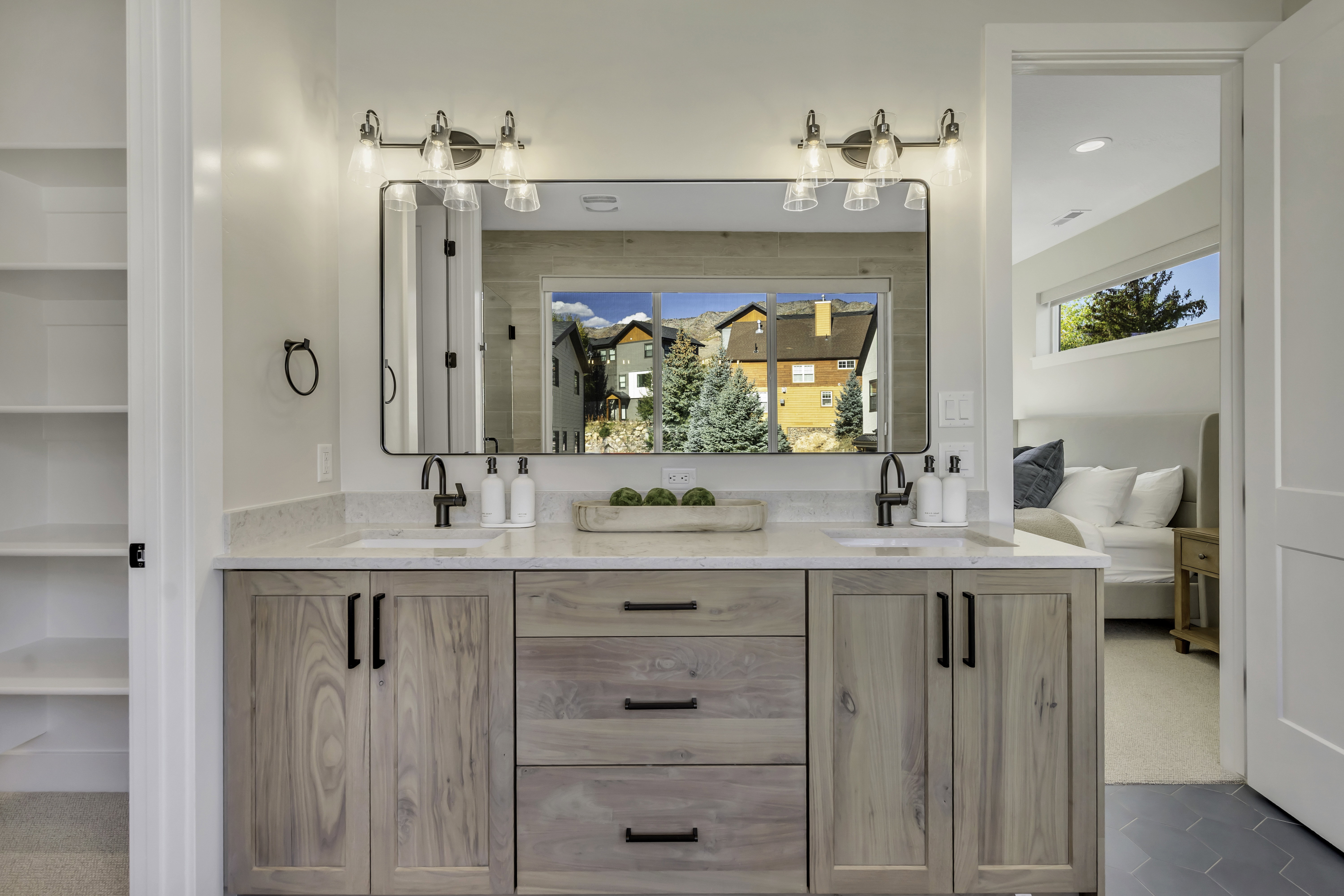 Full bath with double vanity, connected bathroom, and carpet flooring
