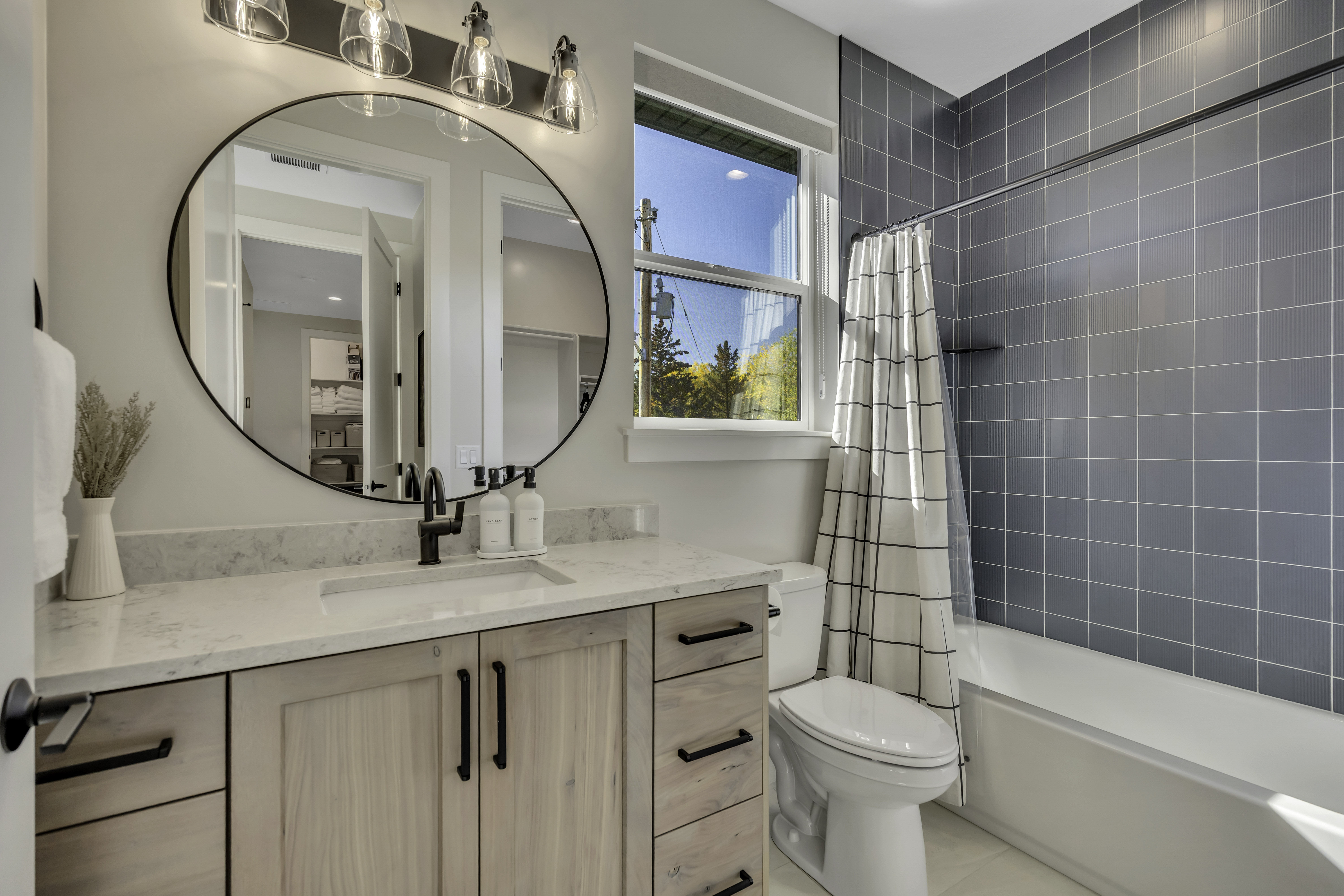 Full bath with vanity, shower / bath combination with curtain, and light tile patterned flooring