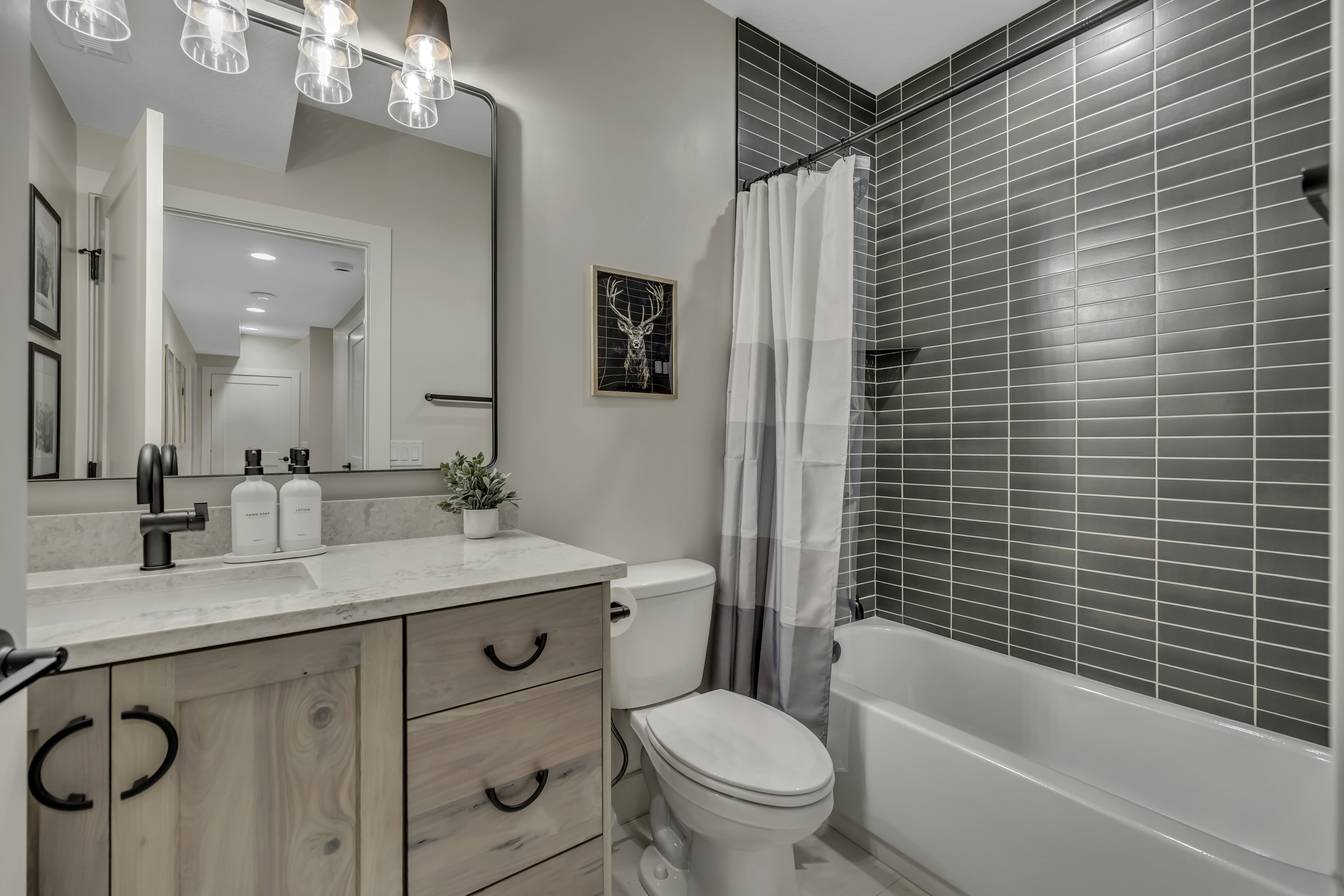 Bathroom with vanity, shower / bathtub combination with curtain, and recessed lighting