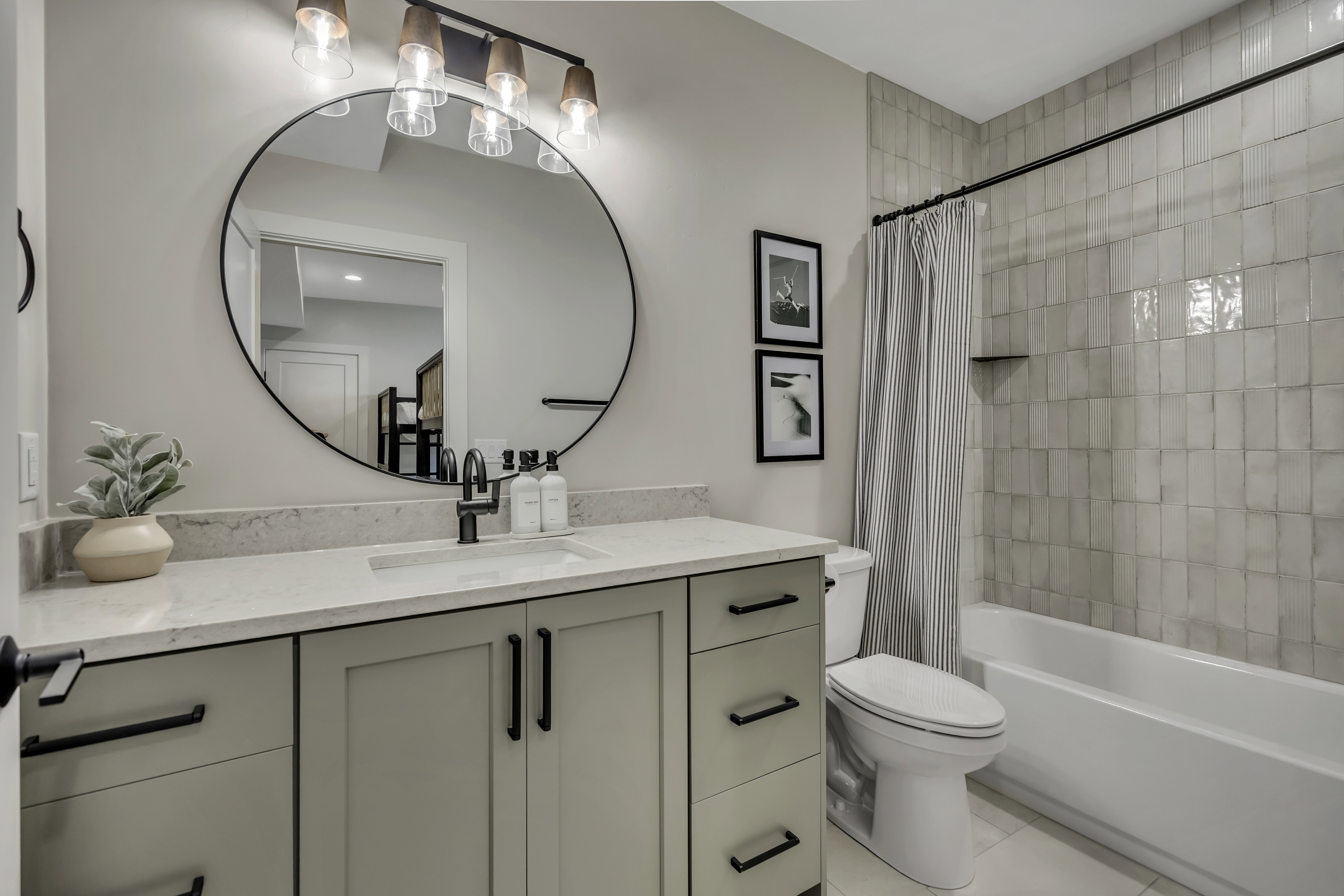 Full bathroom with vanity, shower / bath combo with shower curtain, and light tile patterned flooring