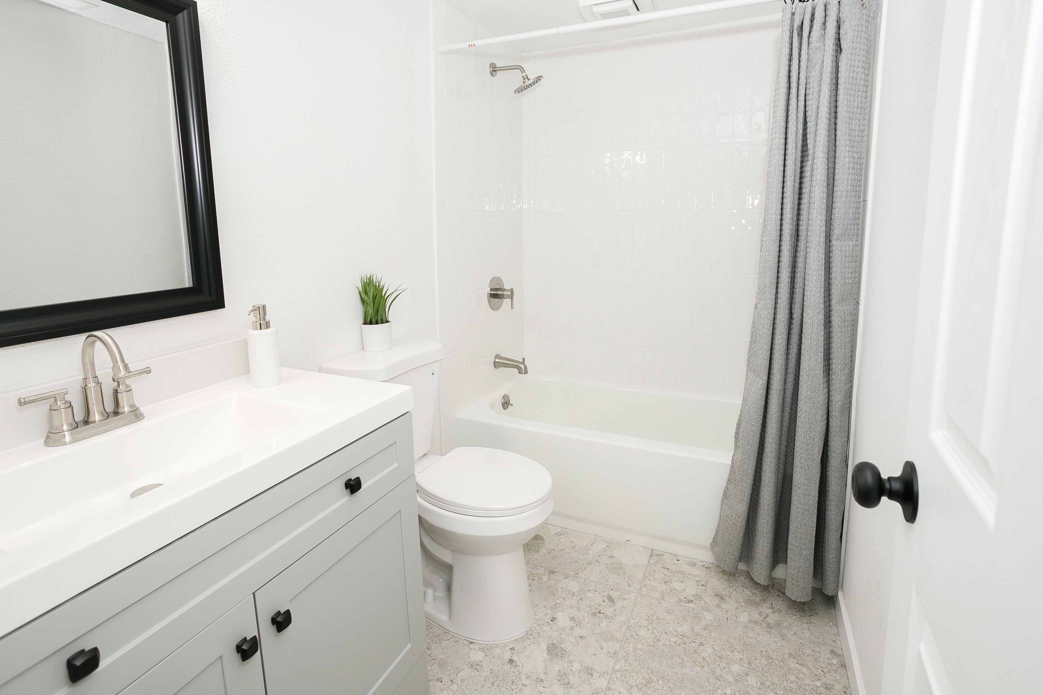 Bathroom featuring a vanity with light gray cabinetry, a white countertop, and a rectangular undermount sink