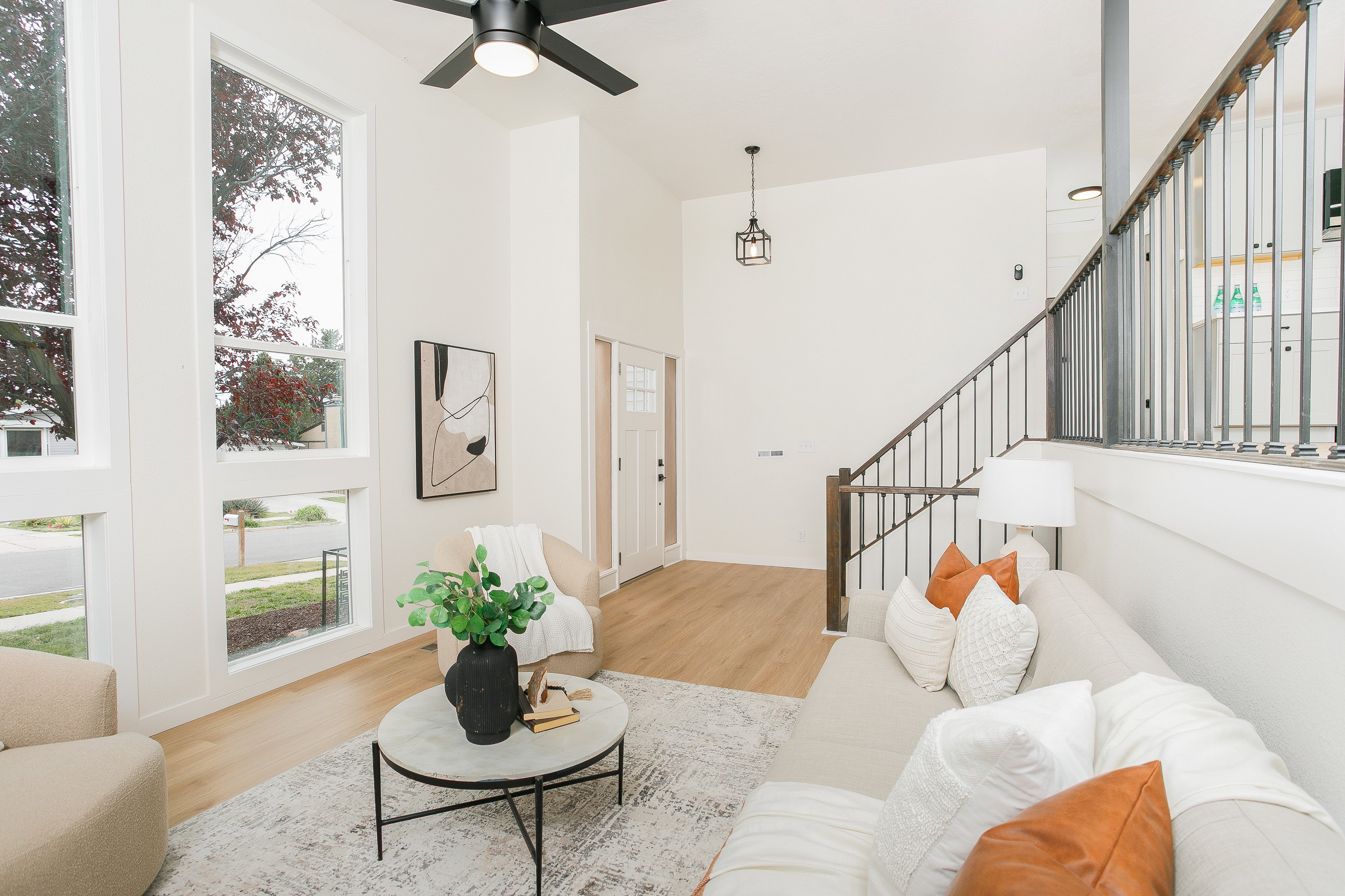 Bright living space featuring tall windows and wood-finish flooring