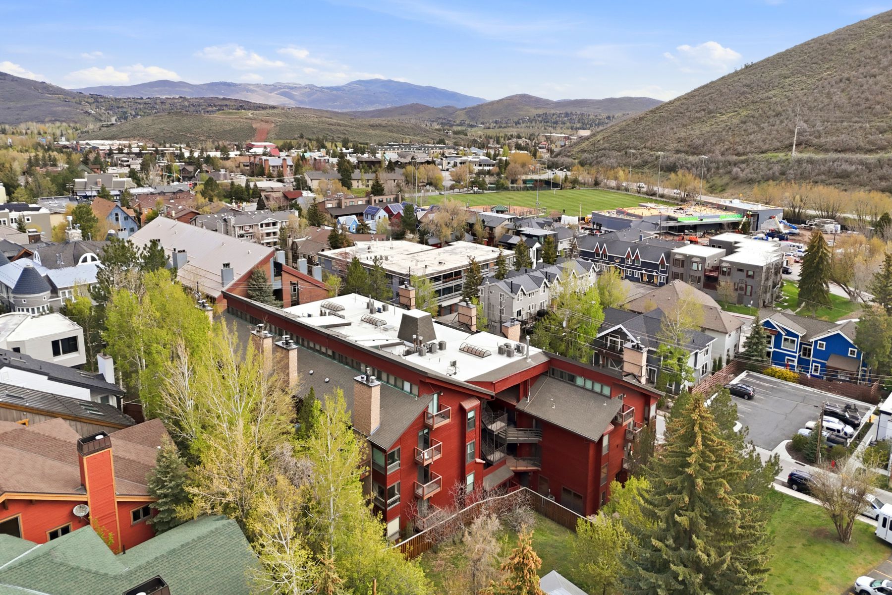 Hillside property featuring a multi-story building with a red exterior