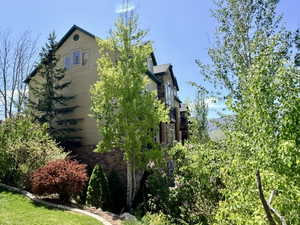 Multi-story building exterior featuring light-toned siding and a dark-toned roof