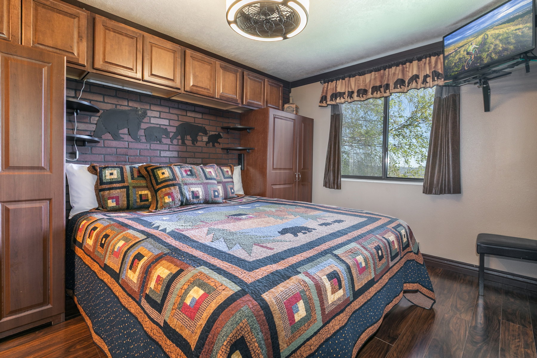 Wood-finish flooring complemented by a brick-patterned accent wall