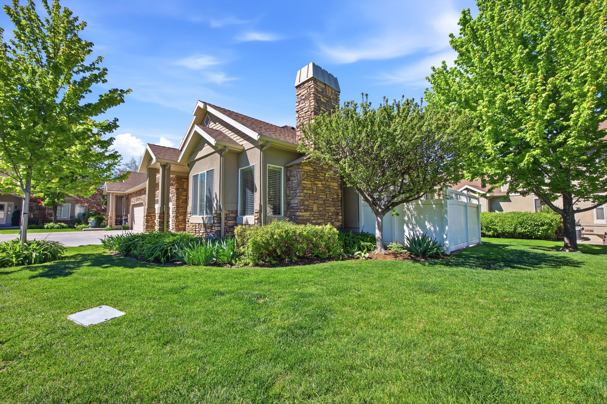 Stone and stucco exterior with multiple gables and a stone chimney