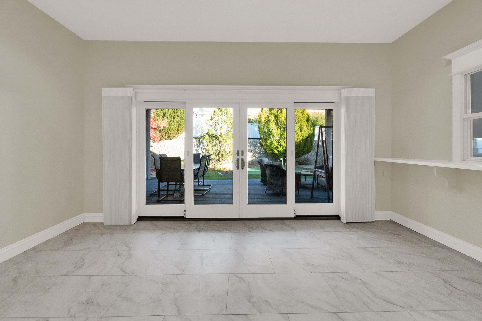 Sliding glass doors opening to the exterior patio