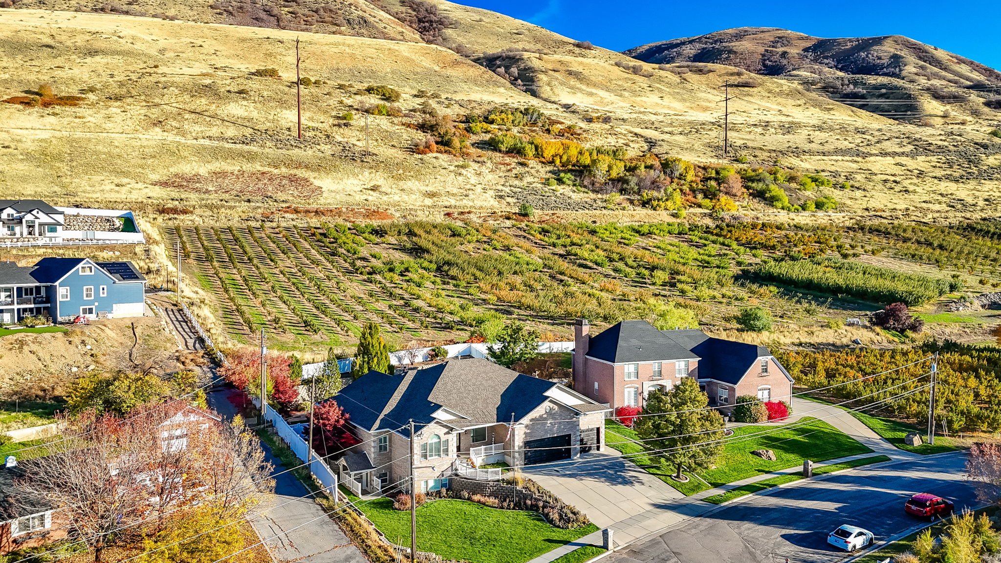 Traditional-style residence with a two-car garage and a paved driveway, set against a mountainous backdrop