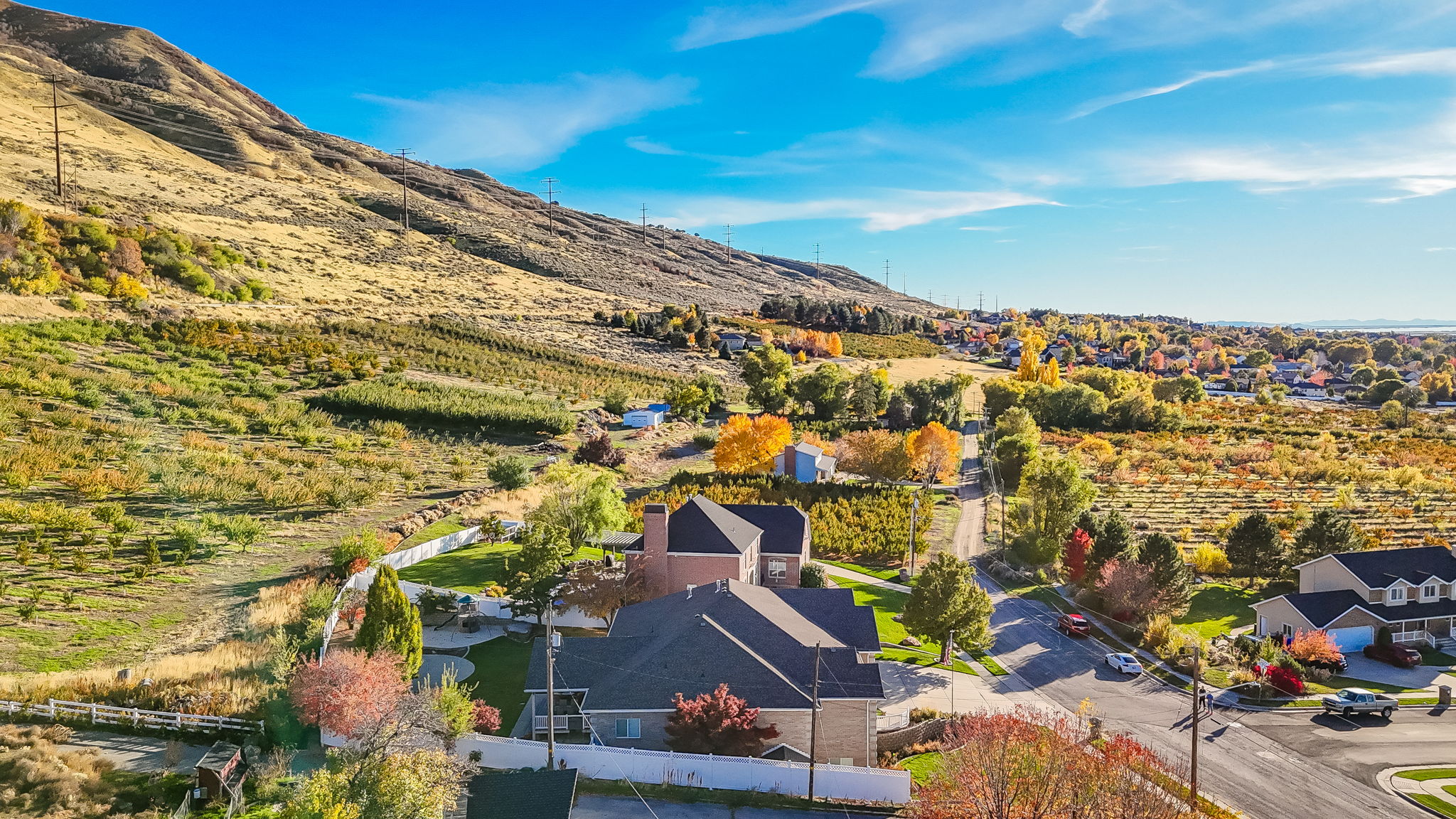 Aerial perspective showcasing a residential area bordered by a prominent hillside