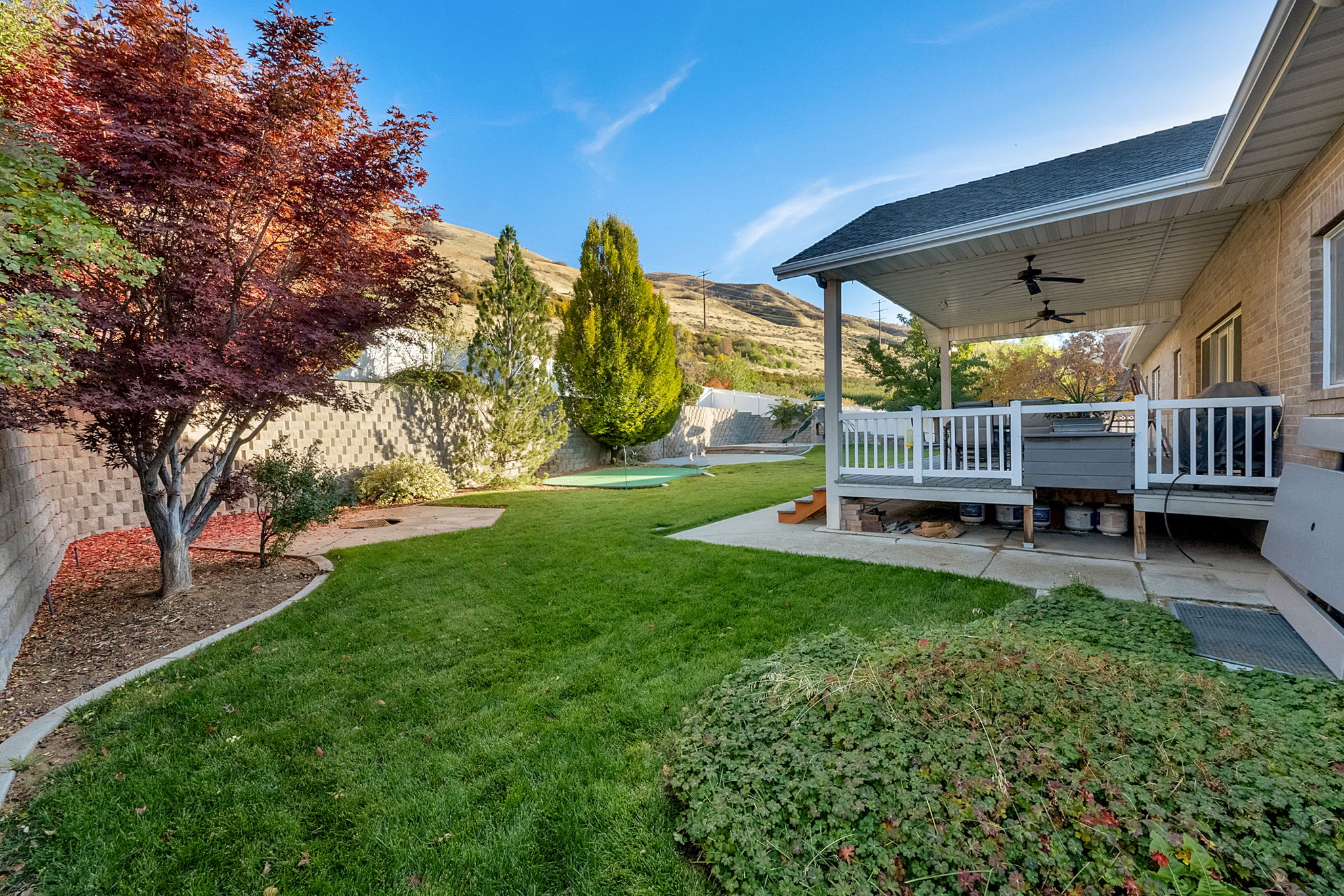 Covered back patio featuring recessed lighting and ceiling fans