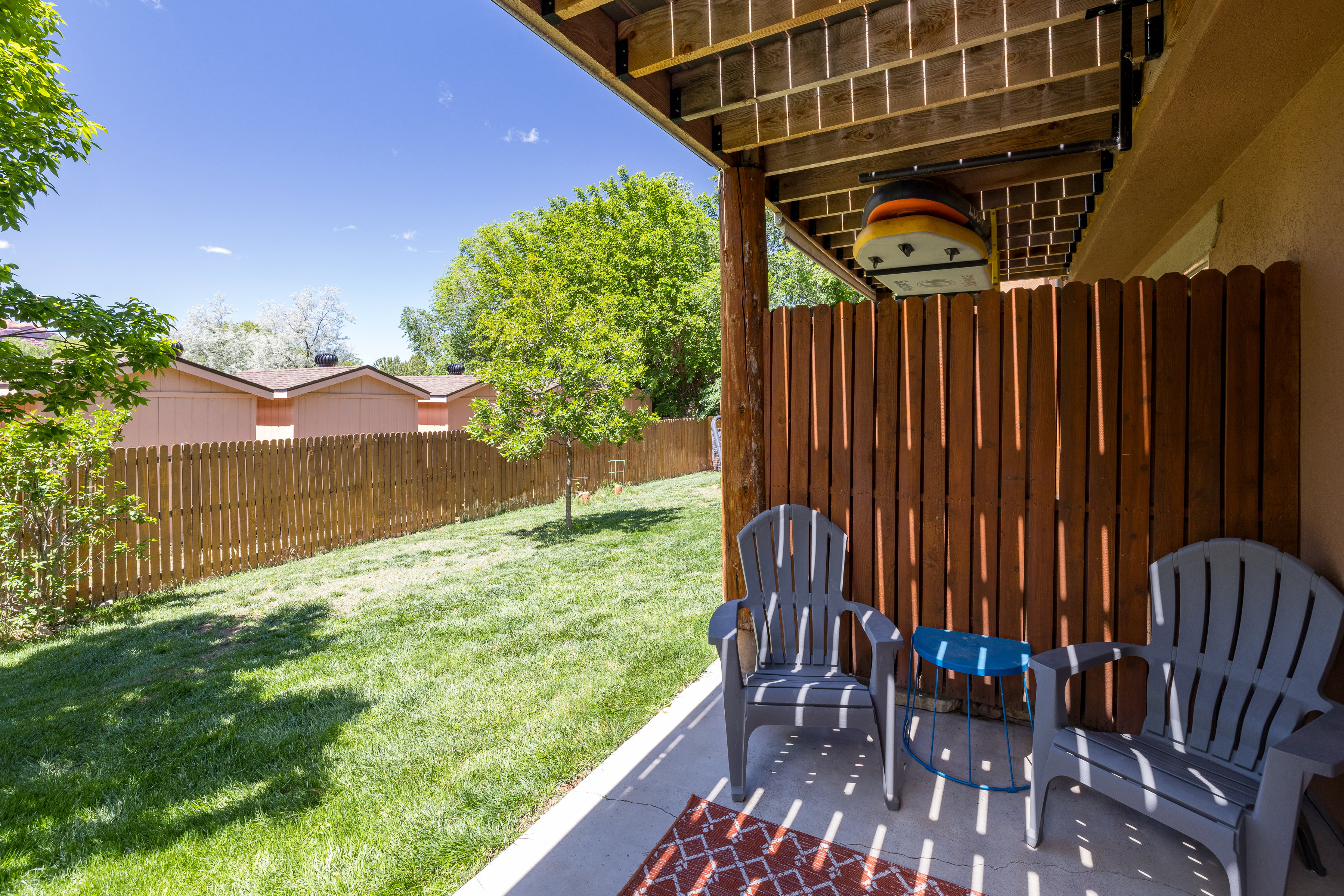 Private patio with concrete flooring, accented by a wood-slat privacy screen