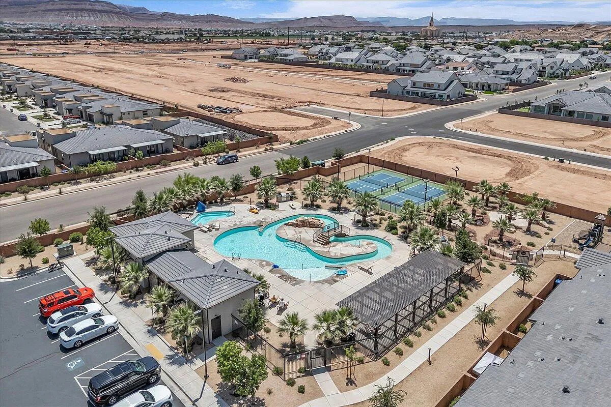 Community amenities featuring a resort-style pool, tennis courts, covered lounge areas, and dedicated parking