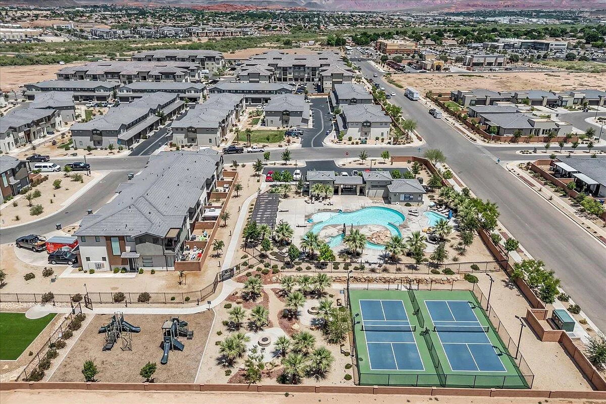 Community amenities featuring a resort-style pool, dual tennis courts, a playground, and multiple multi-story residential buildings