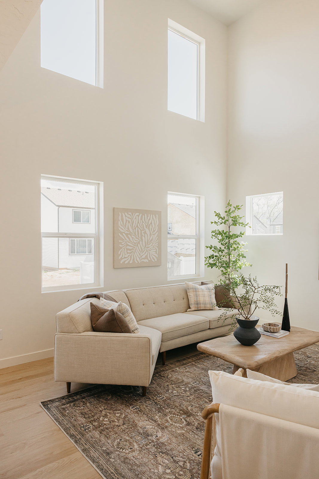 Living area with high ceilings and multiple windows