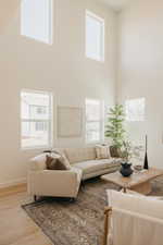 Living area with high ceilings and multiple windows