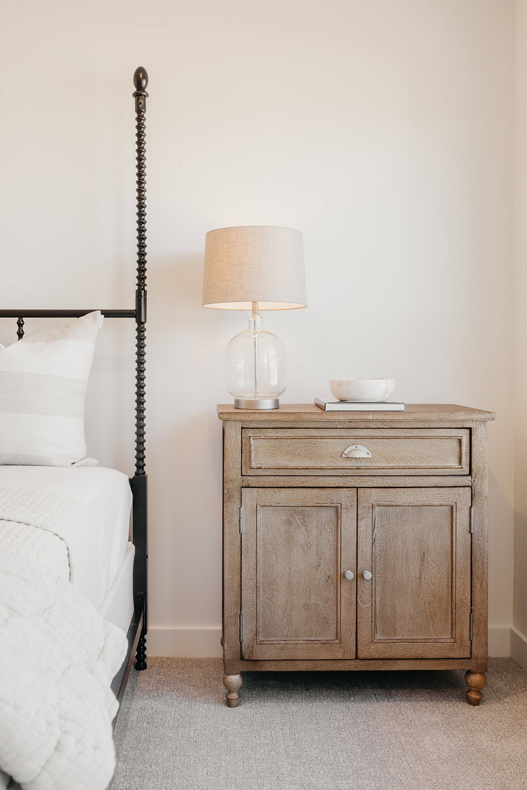 Light-toned wall with white baseboards