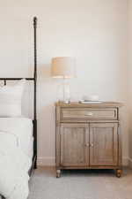 Light-toned wall with white baseboards
