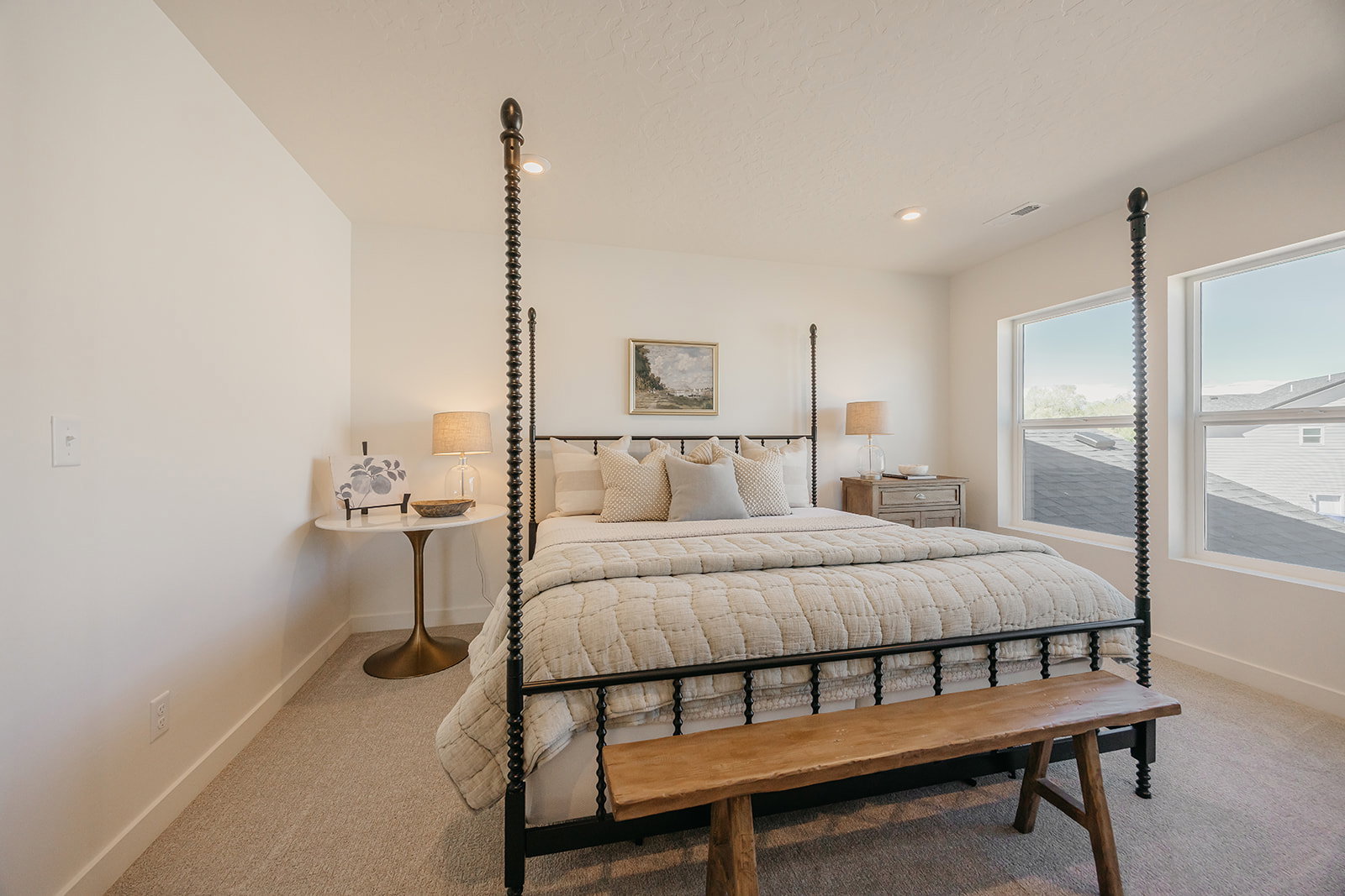 Spacious room with plush carpet flooring, two large windows, recessed ceiling lighting, and crisp white walls