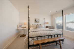 Spacious room with plush carpet flooring, two large windows, recessed ceiling lighting, and crisp white walls