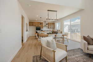 Open-concept living area featuring wood-finish flooring and abundant natural light from the large sliding glass door