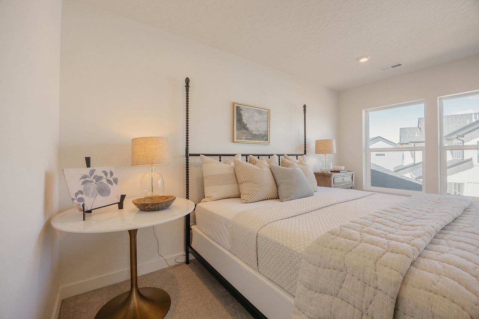 Light-filled interior space with recessed lighting and two large windows