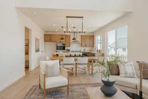 Open-concept living space featuring wood-finish flooring, recessed lighting, and a neutral color palette