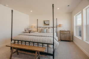 Carpeted room featuring recessed lighting, white baseboards, and two windows