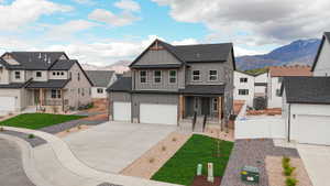 Modern two-story residence featuring a dark gray siding exterior and contrasting white trim